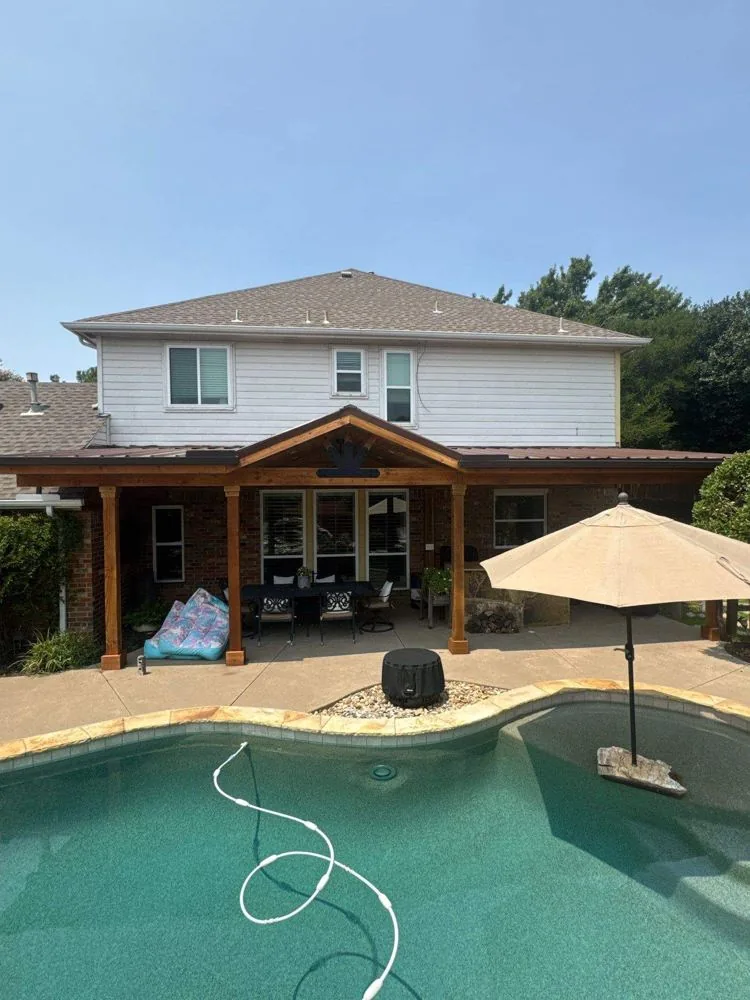 Covered patio and pool with a shade umbrella