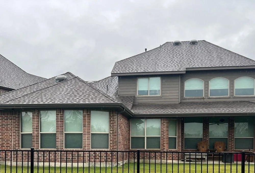 Brick two-story home with only a small original back porch before construction