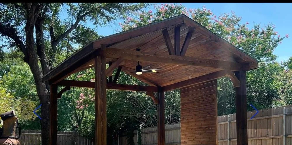 Freestanding cedar pavilion with a gable roof on a lawn