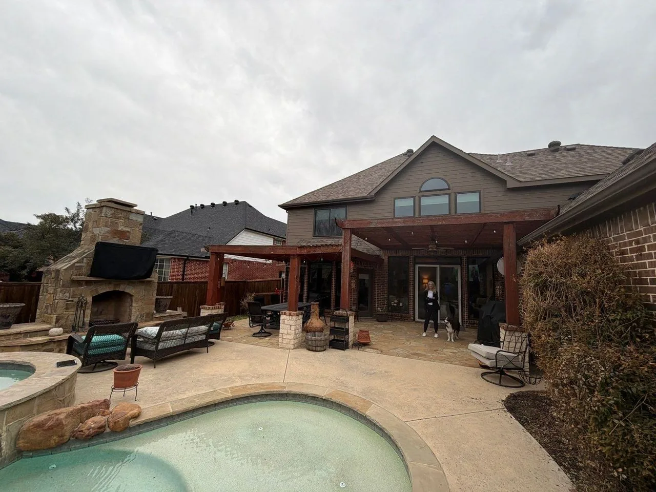 Old weathered pergola over the same pool patio before renovation