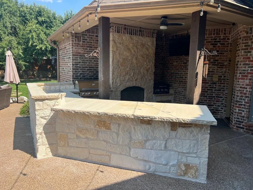 Stone outdoor bar and kitchen under a covered patio